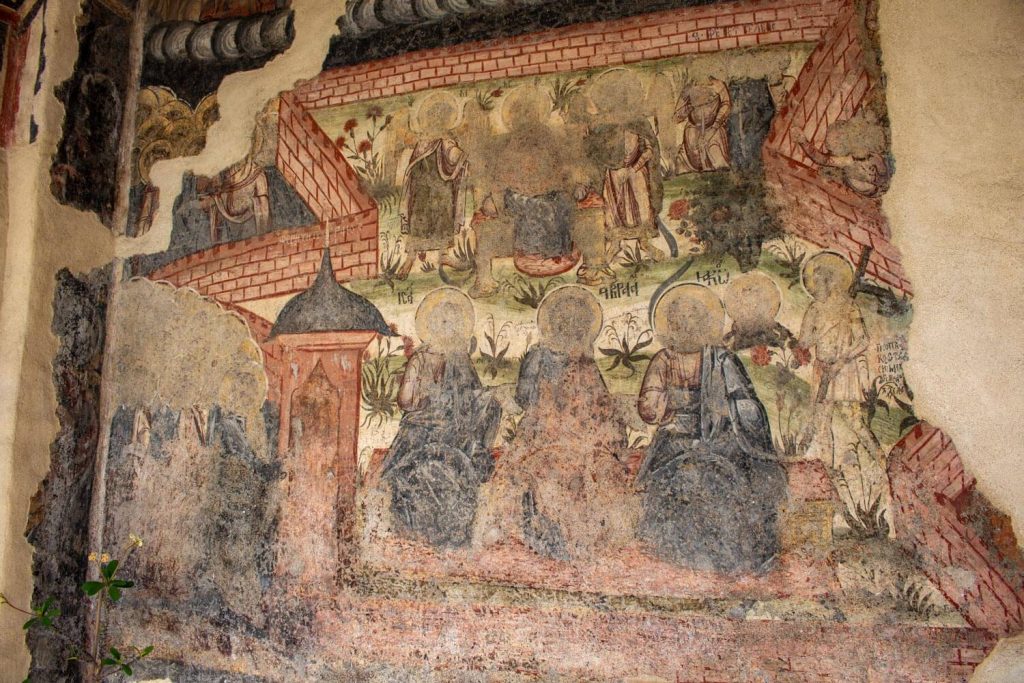Mural painting on the wall next to the entrance of the church