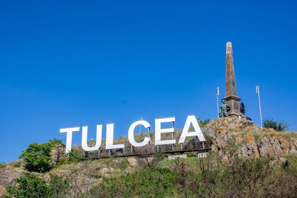 Heroes Monument and Tulcea sign Heroes Monument and Tulcea sign